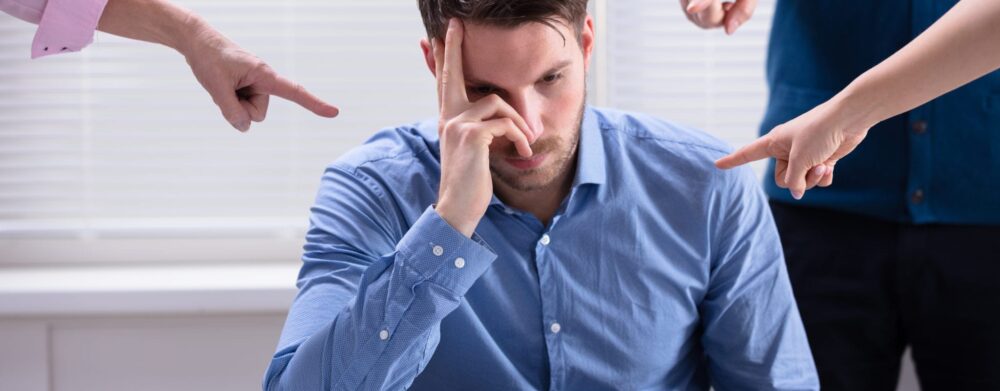 Retaliation: Facing Negative Treatment For Reporting a Coworker? | Header Image | McOmber McOmber & Luber